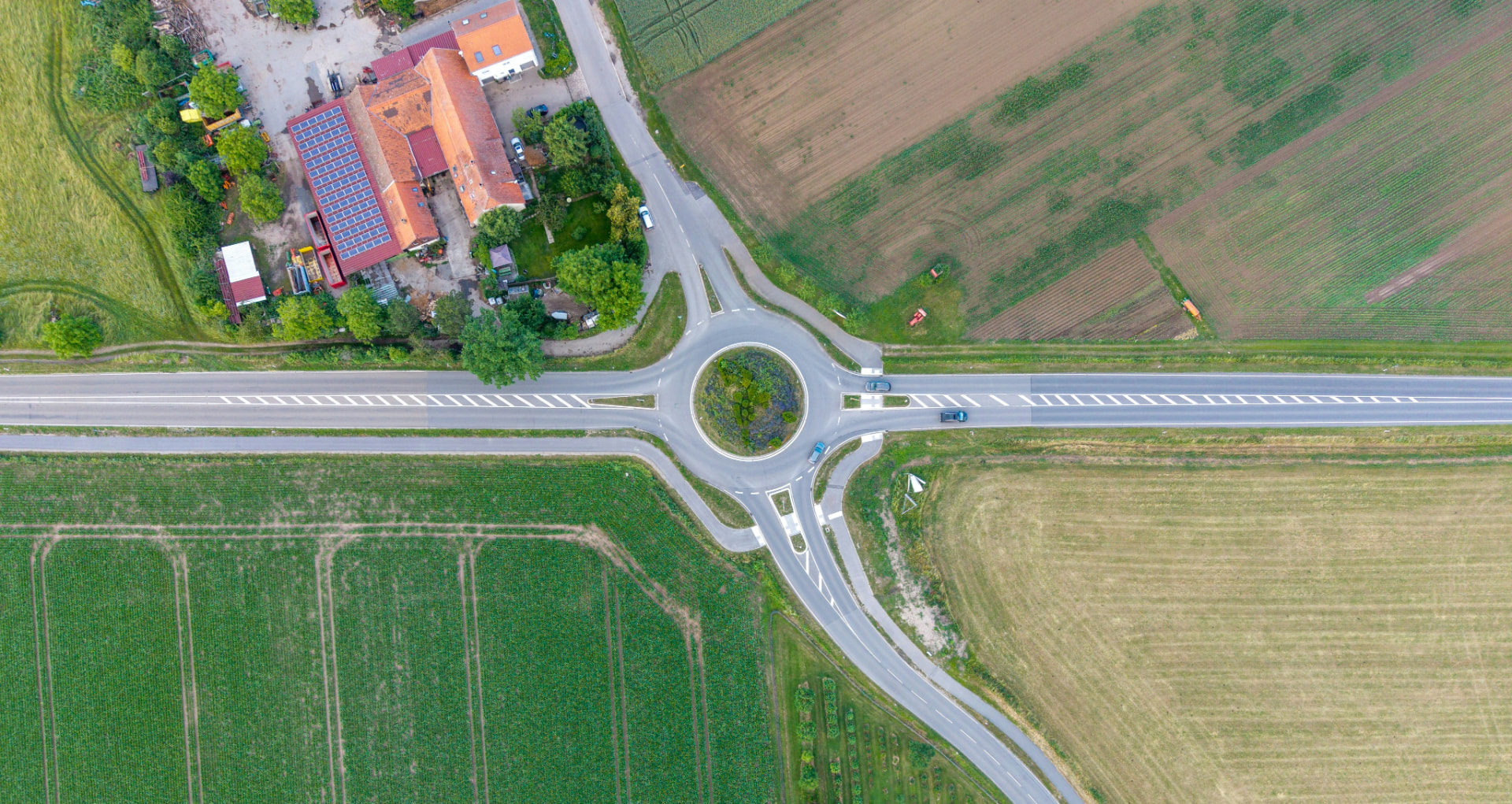 Aerial view of a roundabout junction surrounded by farmland
